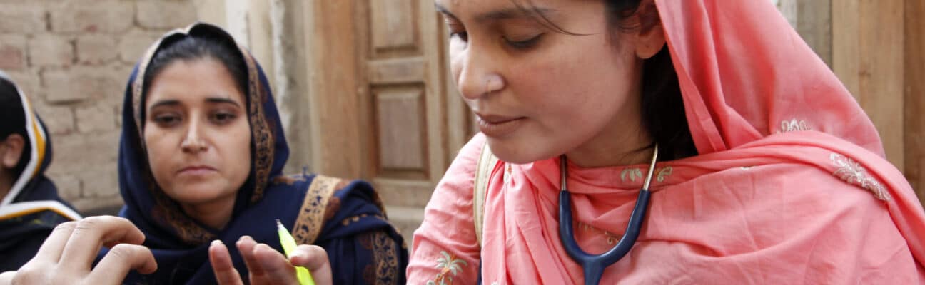 A female doctor with the International Medical Corps examines a woman patient at a mobile health clinic in Pakistan