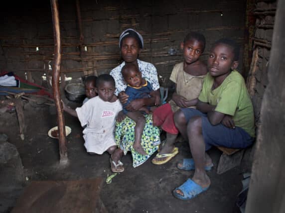 Woman and children sit in a home