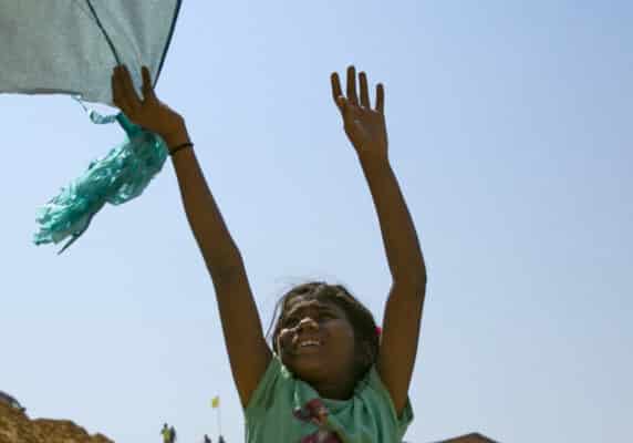 Girl playing with a kite in Rohingya refugee camp