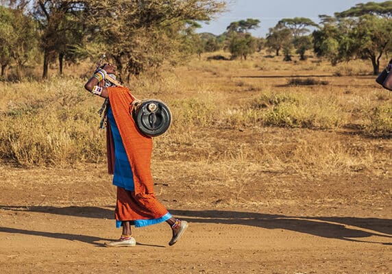 women from Maasai tribe carrying water, Kenya, East Africa