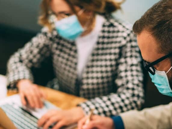 Man and woman work on a laptop