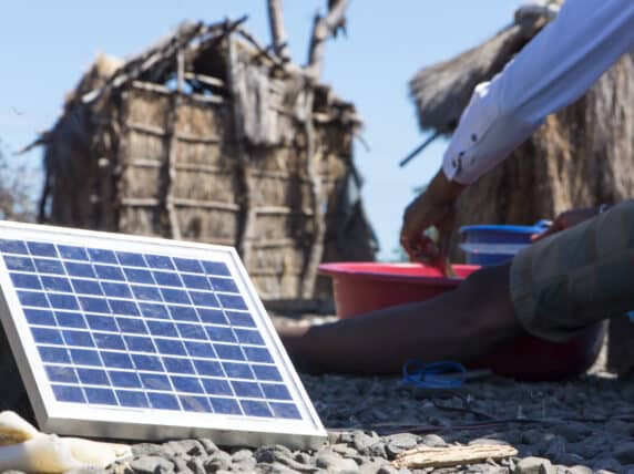 Solar panel next to a man eating