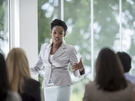 A woman presenting to colleagues