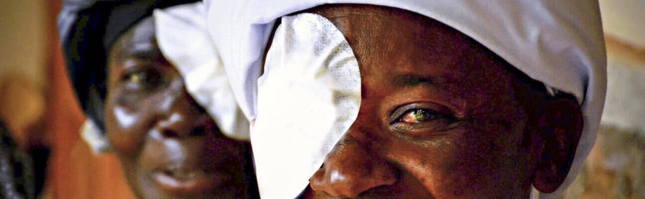 Woman in Kenya waiting to have eye patch removed after surgery by The Fred Hollows Foundation