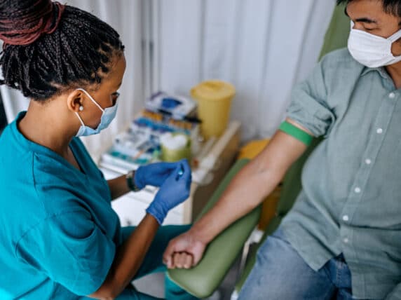 Doctor preparing patient to do a blood test.