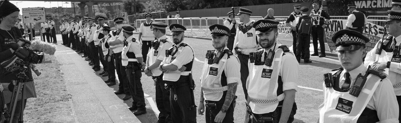 Police protect DSEI Arms Fair from blockade attempt. Credit: Alisdare Hickson