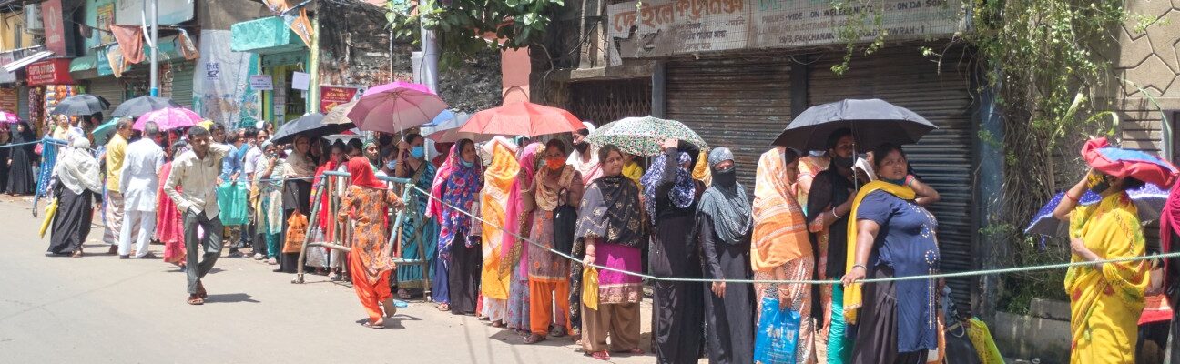 Women queue in Howrah Maidan, West Bengal.